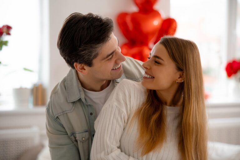 Happy,Young,Couple,Smiling,And,Looking,At,Each,Other,At
