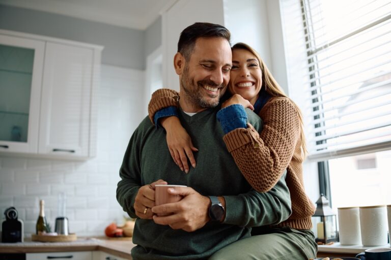 Happy,Woman,Embracing,Her,Husband,While,Spending,Time,Together,At