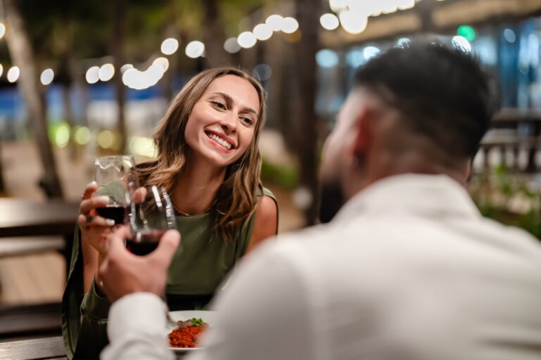 Romantic,Couple,Enjoying,An,Intimate,Dinner,Under,String,Lights,At