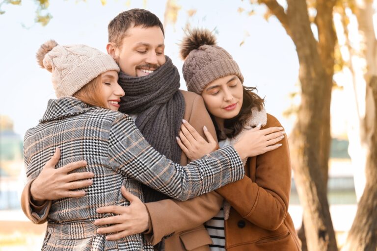 Man,And,Two,Beautiful,Women,Hugging,In,Autumn,Park.,Polyamory