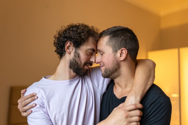 Affectionate,Gay,Couple,Hugging,And,Touching,Foreheads,In,A,Warm