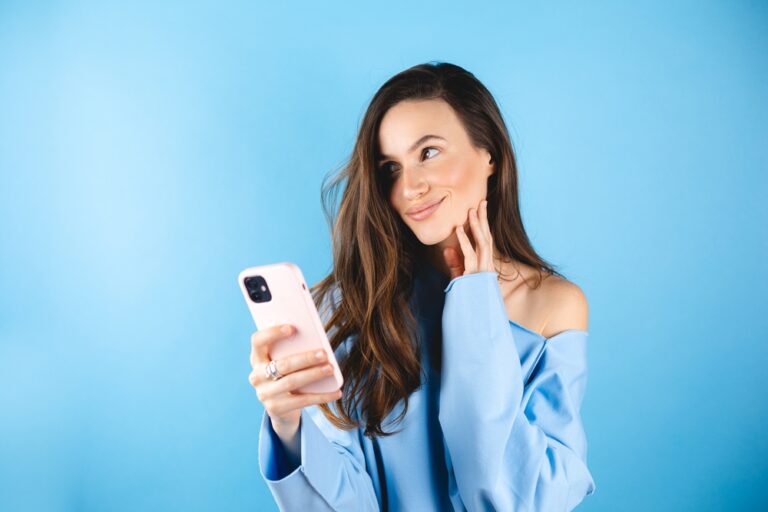 Smiling,Beautiful,Young,Woman,In,Blue,Pullover,Isolated,On,Blue